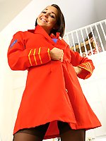 Beautiful brunette in bright red air hostess jacket and dark stockings.